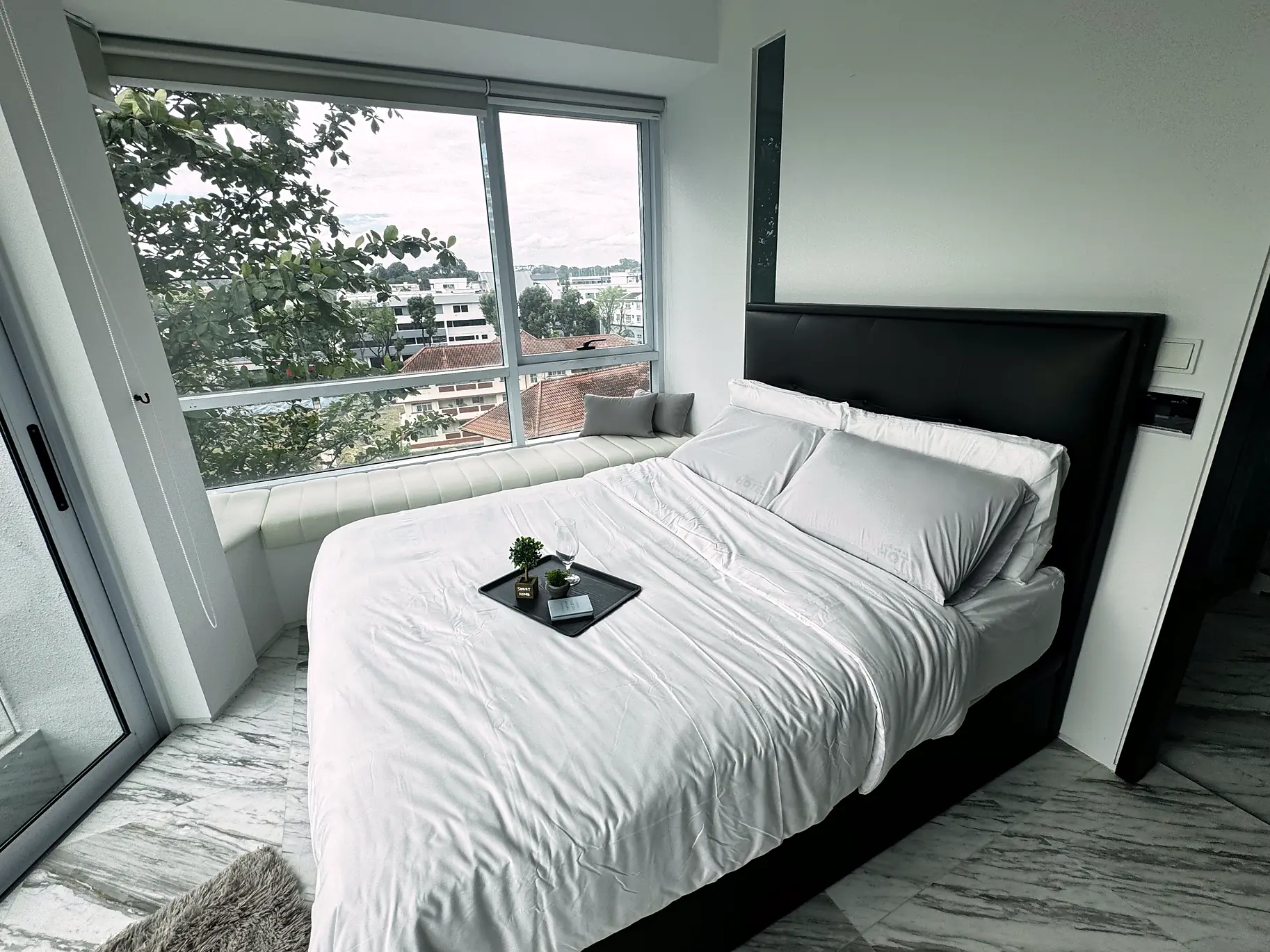 Bright Rumah Suite Room 1 at Fifty Two Stevens with queen bed, window seat and greenery views