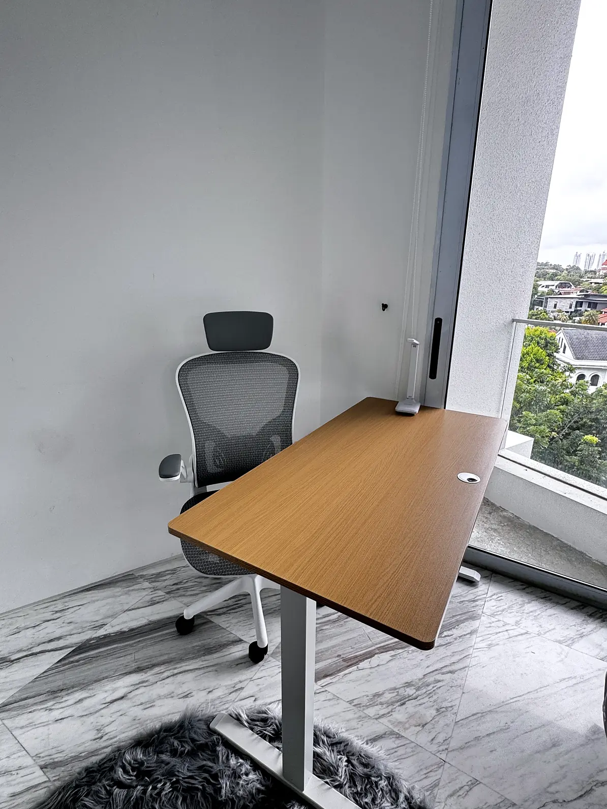 Study desk and ergonomic chair by the window in Fifty Two Stevens Rumah Suite Room 2