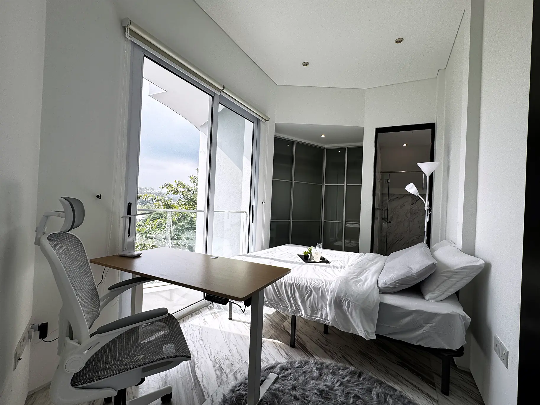 Rumah Suite Room 2 at Fifty Two Stevens with bed, study desk and balcony views