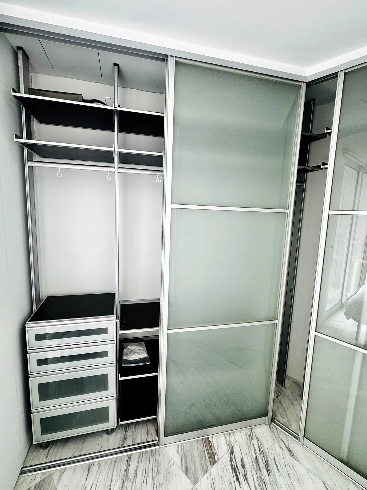 Built-in wardrobe with drawers and sliding doors in Fifty Two Stevens Rumah Suite Room 2