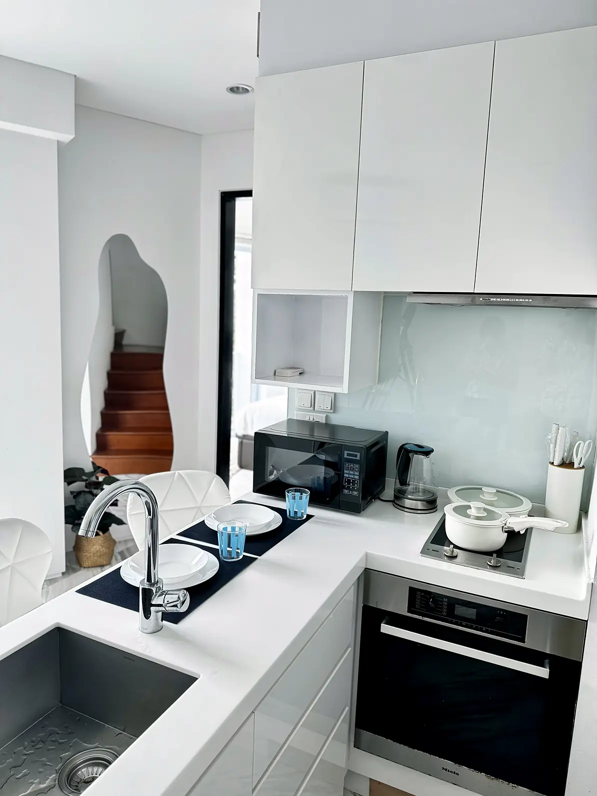 Modern kitchen with built-in oven, cooktop and sink at Fifty Two Stevens