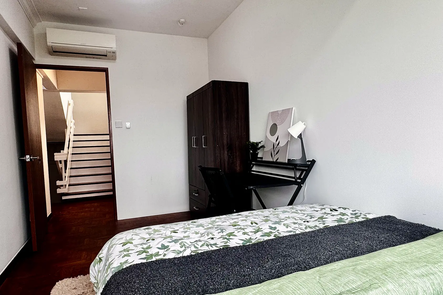 View from the door of Pandan Valley Jendela Room 5 showing bed, desk and wardrobe