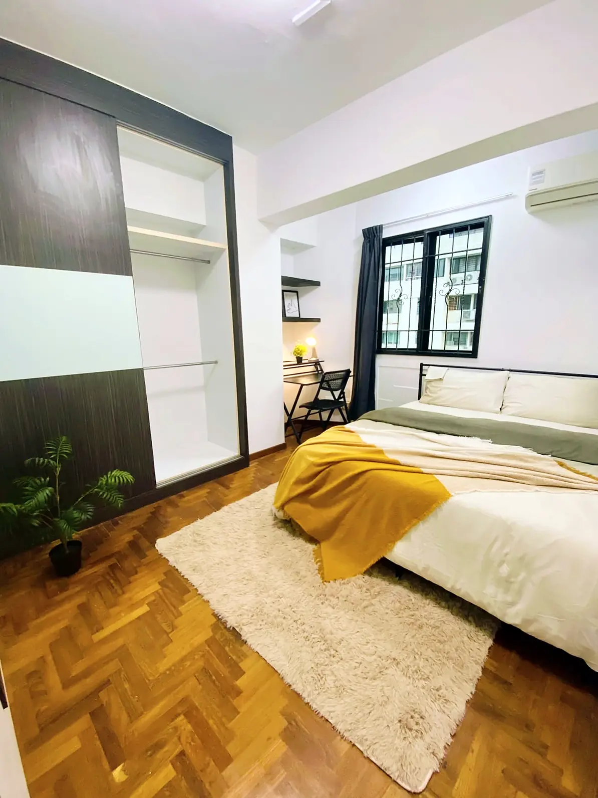Queen bed and open wardrobe in Pandan Valley Rumah Suite Room 8