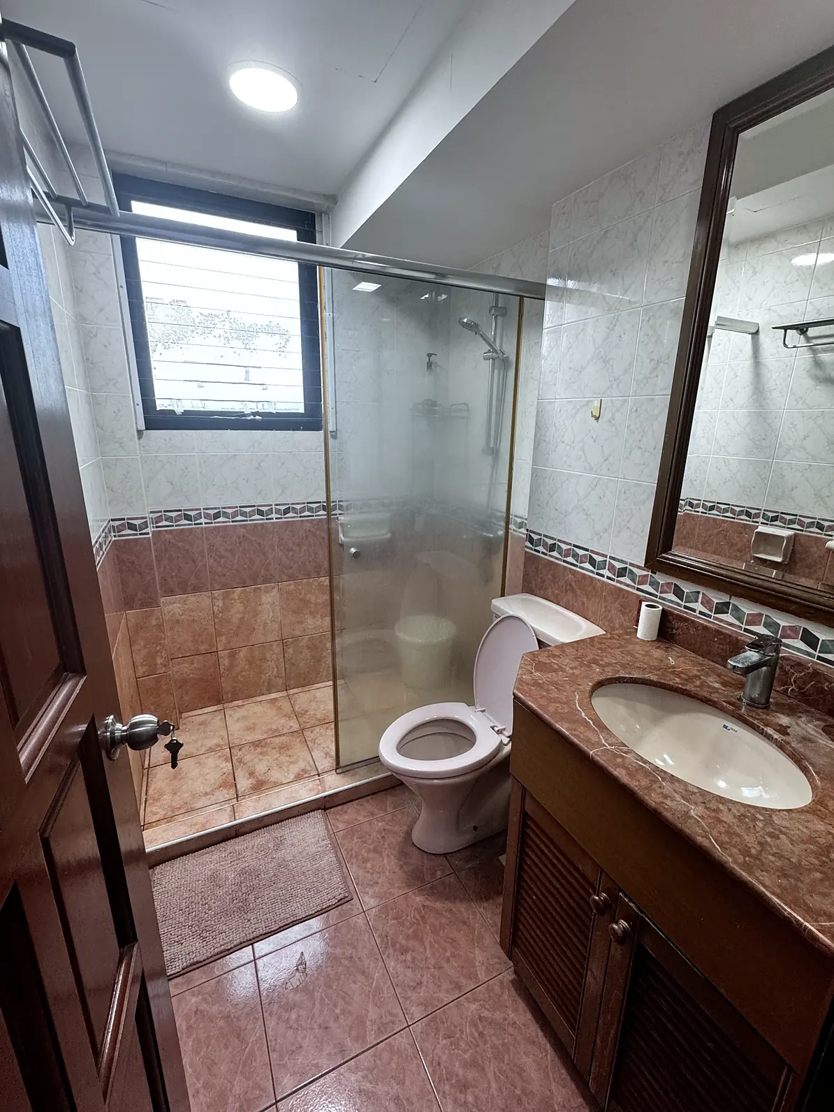 Private ensuite bathroom with glass shower in Simsville Rumah Suite Room 3