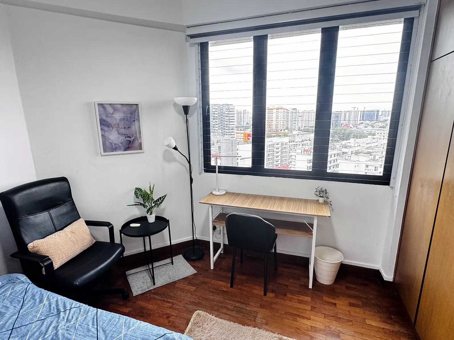 Study desk, armchair and city-view windows in Simsville Rumah Suite Room 3