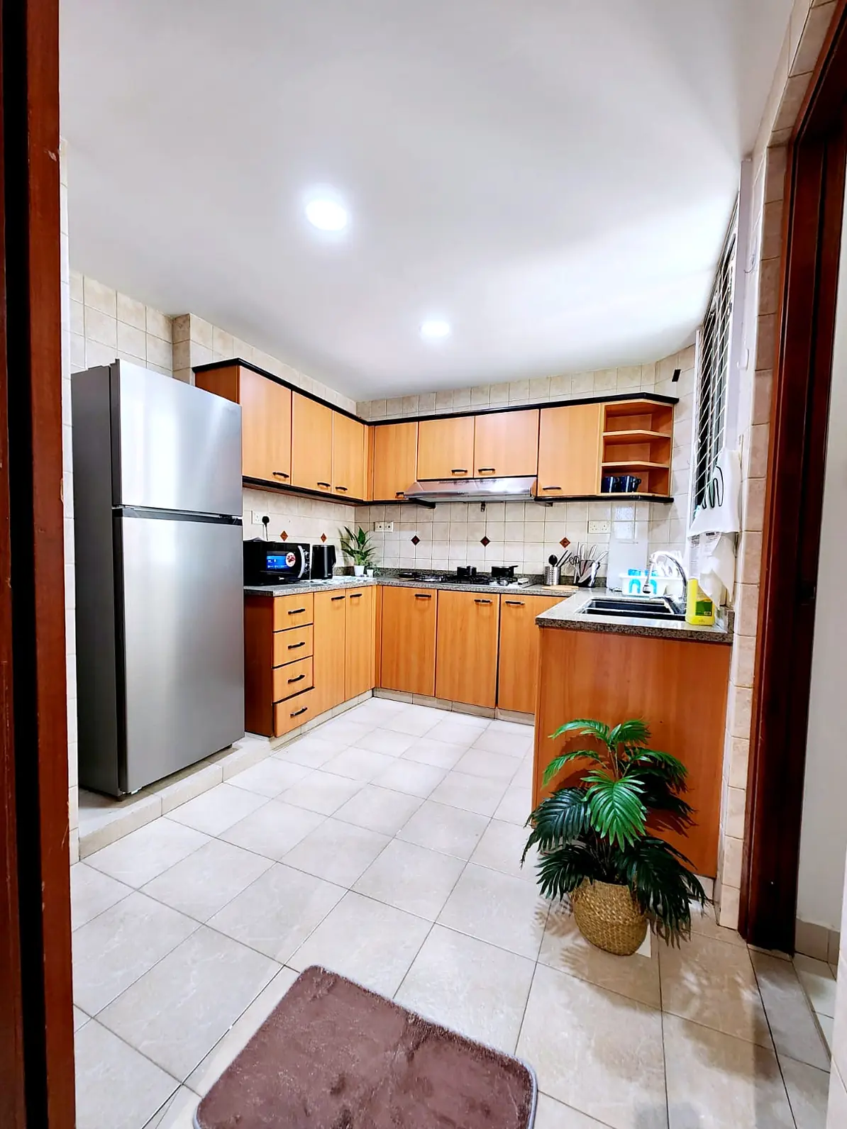 Shared kitchen with fridge and full cabinetry at Simsville