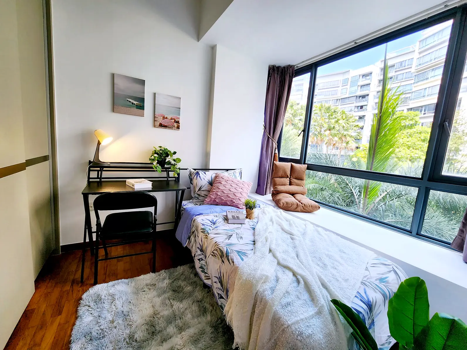 Study desk and bed by the large window in The Palette Kampung Room 3